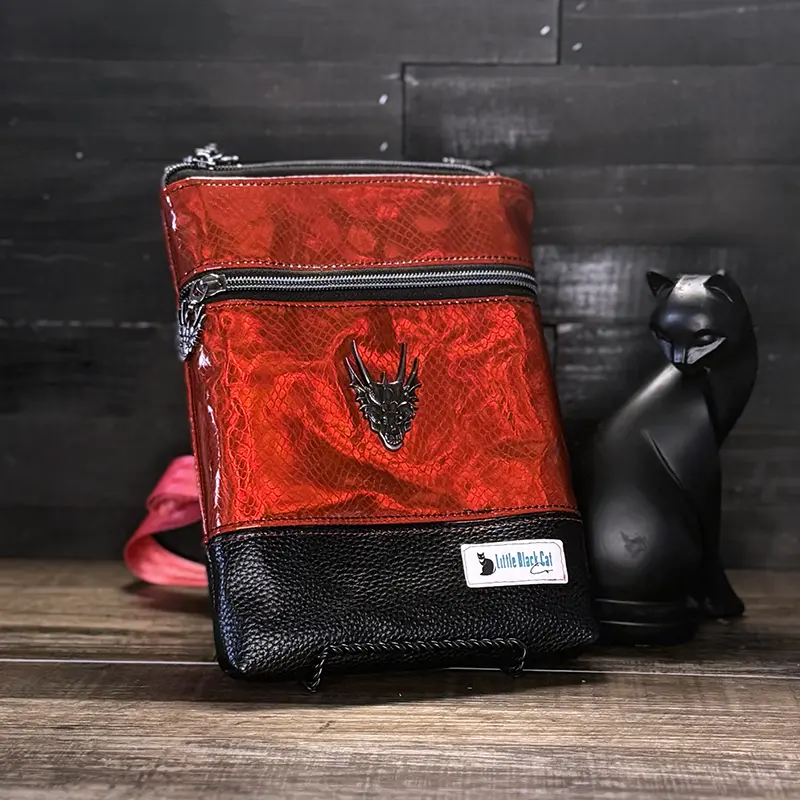 small crossbody phone bag with a wolf design in blue